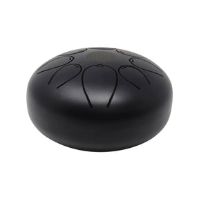 Matte black steel tongue drum, angled side view showing smooth domed profile and Flower of Life mark