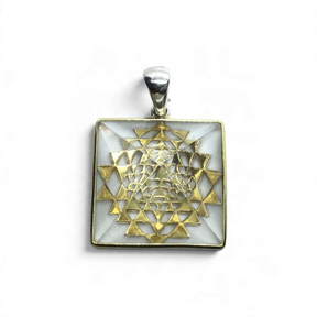 Rare Earth Gallery quartz pyramid pendant in 925 sterling silver with a gold plated mandala accent and simple bail.