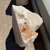 Top view of serpentine onyx boulder fountain showing the drilled center hole and rust inclusions