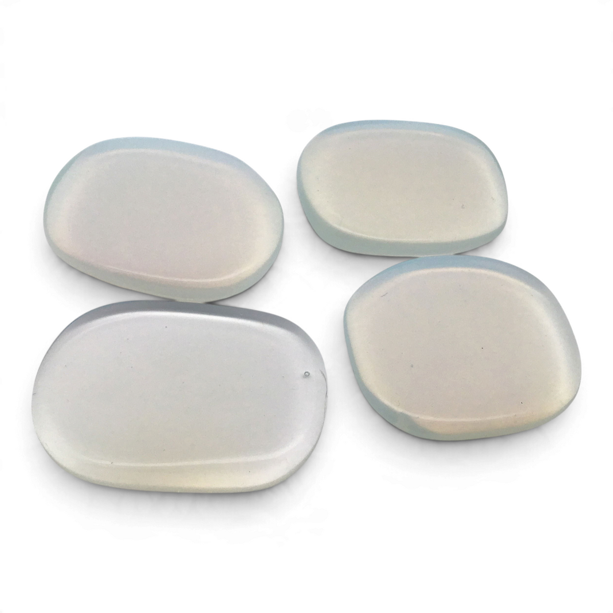 Four opalite flat stones with milky white bodies, pale blue edges and a glossy polish