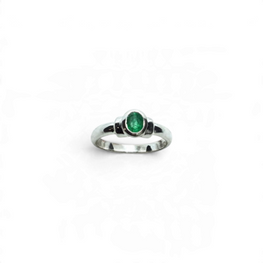 Rare Earth Gallery emerald ring featuring a bezel set faceted oval stone with step shoulder detail on a silver band.