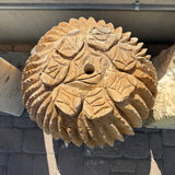 Top-down detail of the sculpted leaf crown and center drill hole on the travertine cactus carving
