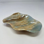 Blue calcite banded freeform dish with flowing blue-gray and caramel bands, polished curved surface