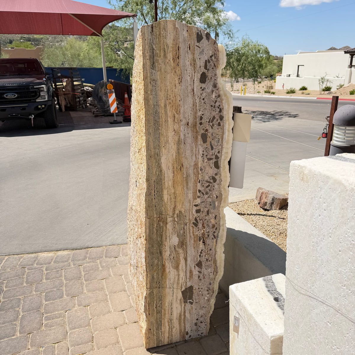 Peach watercolor back of the ice onyx and caliche vertical fountain, banded stone with dark embedded clasts