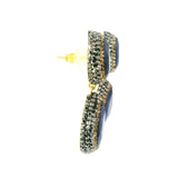 Side profile of blue sapphire two-pear dangle earrings showing gold posts and crystal-set drops