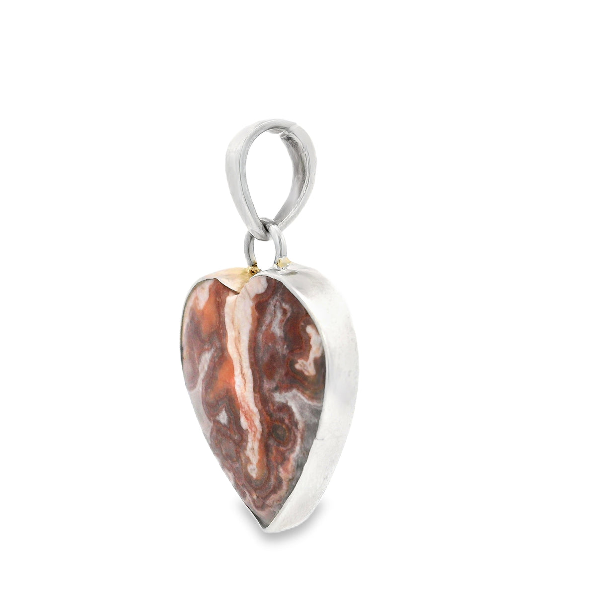 Crazy lace agate heart pendant seen from the side, showing the rust banded stone's thickness and silver bezel