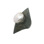 Coin pearl ring, white pearl bezel-set on oxidized sterling silver pointed band, angled side view