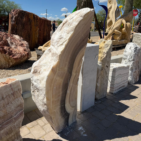 Polished face of the Cosmic Sunset Fossil Zebra Onyx pillar fountain, crescent bands of tan, cream and brown