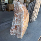 Three-quarter view of the Red Sunset onyx and travertine fountain, wedge form with rust and white layers