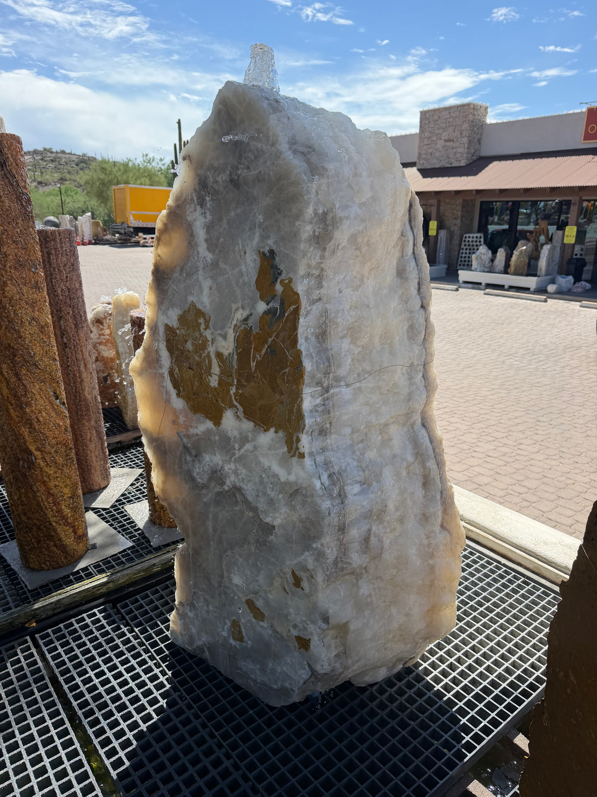White crystal and gray onyx band fountain with gold and gray mineral patches, water bubbling from the top