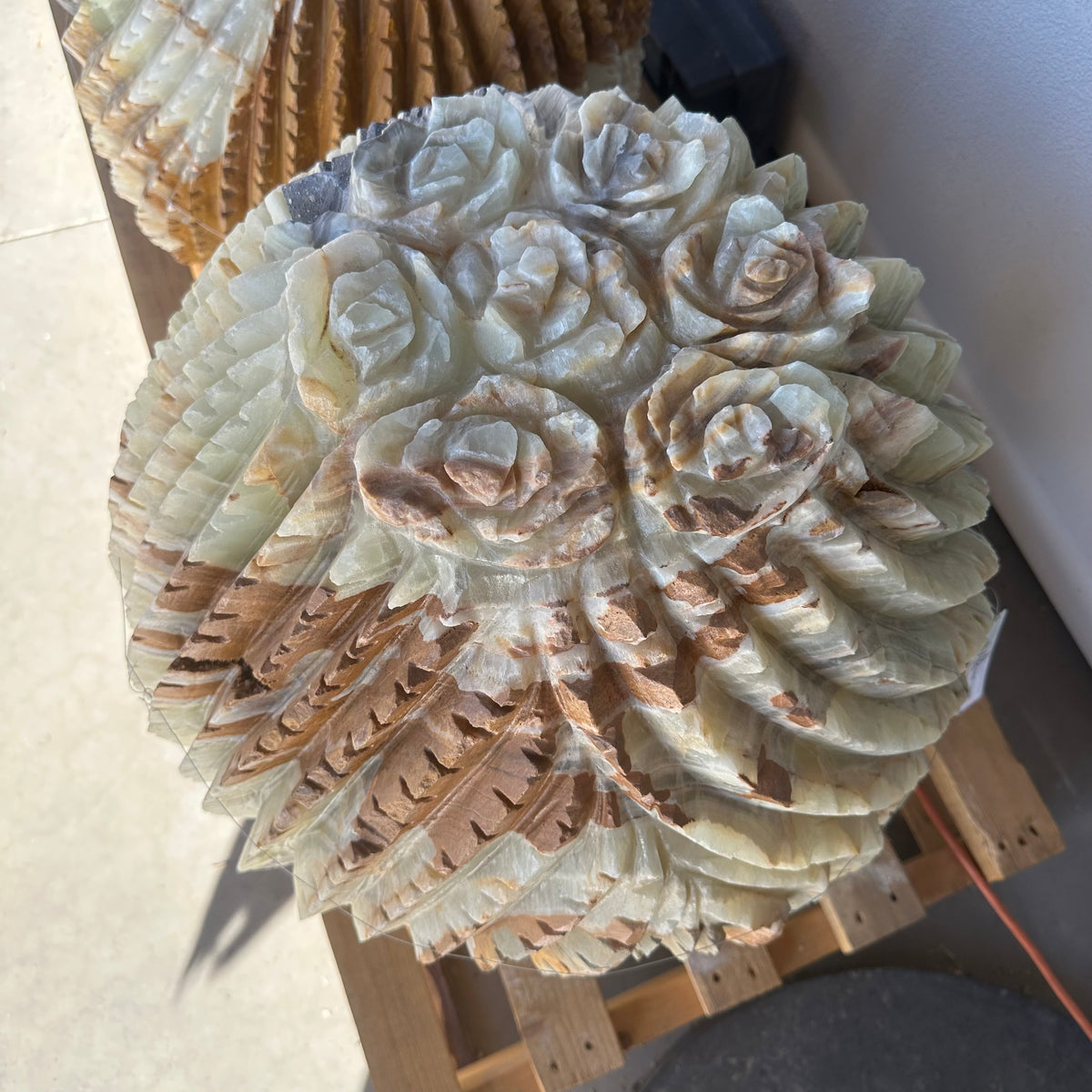 Crown of the Green Talan barrel cactus viewed from above, carved as clustered stone rose blooms