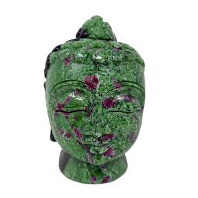 Green stone Buddha head sculpture on a white background