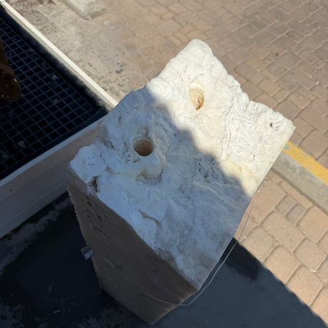 Top view of the White Cosmic Onyx fountain pillar with two drilled water holes in its rough-cut crown
