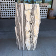 Zebra onyx fountain slab with cream, gold and gray banding standing upright on the gallery patio
