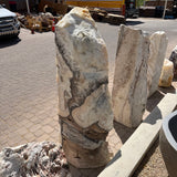 Sunlit Cosmic Orange Zebra Onyx fountain column showing crystalline white top and dark diagonal veining