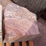 Red zebra onyx fountain stone showing swirling floral radial banding across its cut top