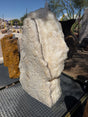 White crystal and gray onyx band fountain running outdoors, sparkling textured crystal face on a drain grate