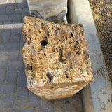 Top view of the travertine onyx fountain monolith with drilled center hole and porous natural texture