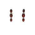 Three faceted red garnet ovals prong set in sterling silver stud earrings