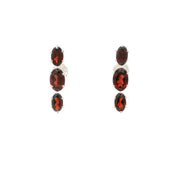 Three faceted red garnet ovals prong set in sterling silver stud earrings