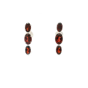 Three faceted red garnet ovals prong set in sterling silver stud earrings