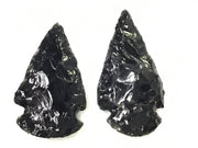 Two small black sheen obsidian arrowheads with knapped flaked edges