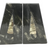 Close front view of Orthoceras fossil bookends, slender tan fossil cones raised on dark speckled seabed stone
