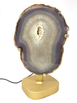 Lavender Agate Druze Slice with Cream Agate Druze Center On Illuminated Table Stand