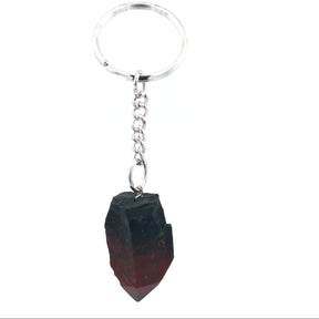 Dark bloodstone point with deep red mottling on silver keychain, angled view