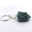 Mottled green-and-white agate point on silver keychain, side view