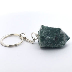 Mottled green-and-white agate point on silver keychain, side view