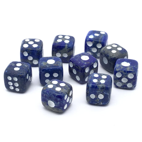 Lapis lazuli dice carvings set of 10 in blue and purple with white dots, arranged on a white background.