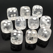 Clear quartz dice carvings set of 10, featuring translucent white dice with silver dots on a black reflective surface.