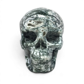 Green and white moss agate skull carving, front view with dark dendritic veining and druzy quartz pockets