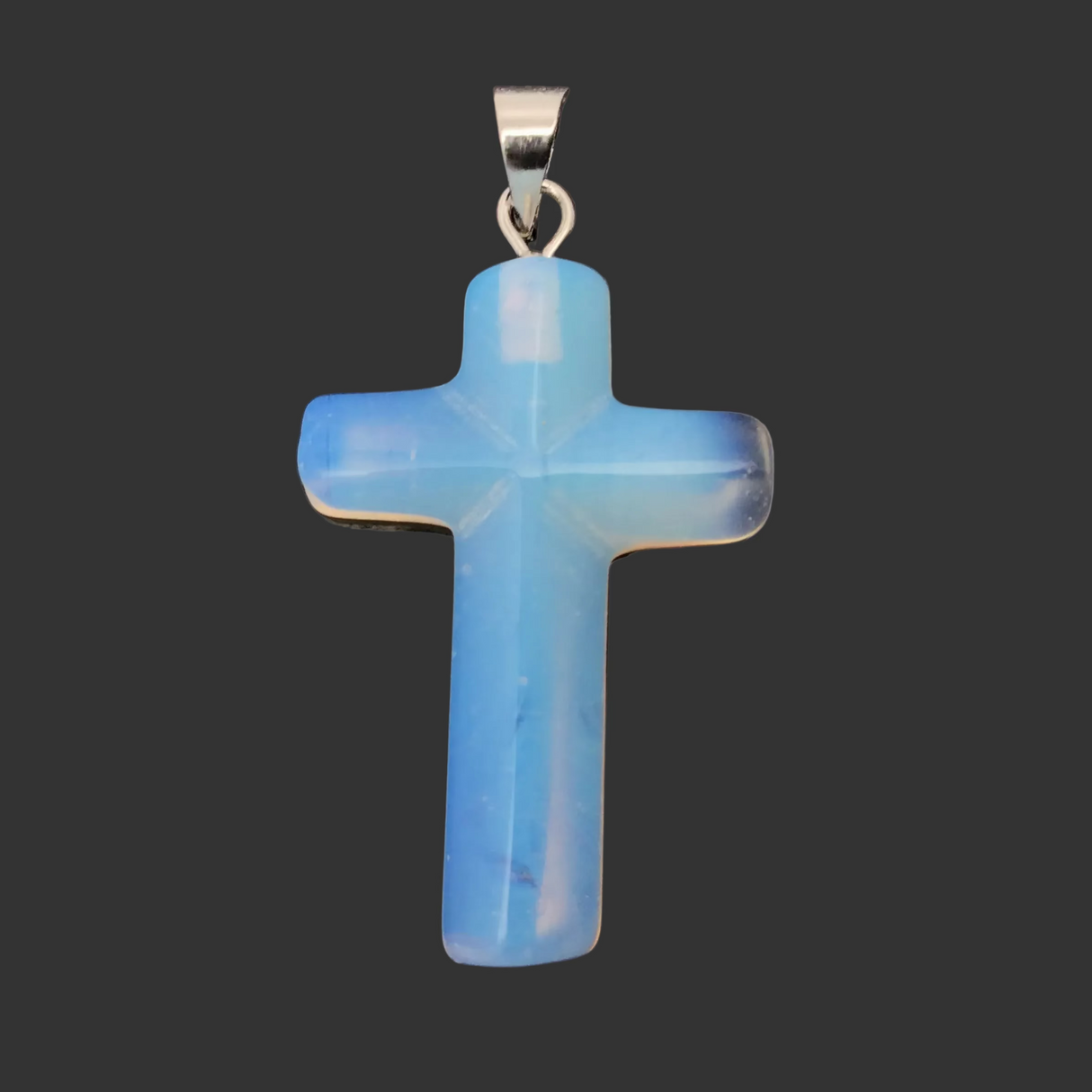Blue cross pendant on a reflective surface