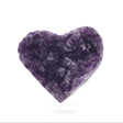 Amethyst crystal heart with deep violet druzy points displayed on a clear lucite easel