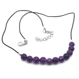 Amethyst 6mm bead cord choker laid flat showing lobster clasp and silver extension chain, purple beads at front