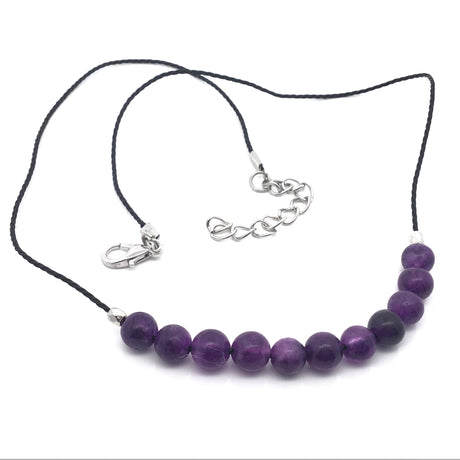 Amethyst 6mm bead cord choker laid flat showing lobster clasp and silver extension chain, purple beads at front