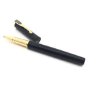 Matte black Muonionalusta meteorite pen with gold-tone ribbed grip, cap set aside and pennant inlay on clip