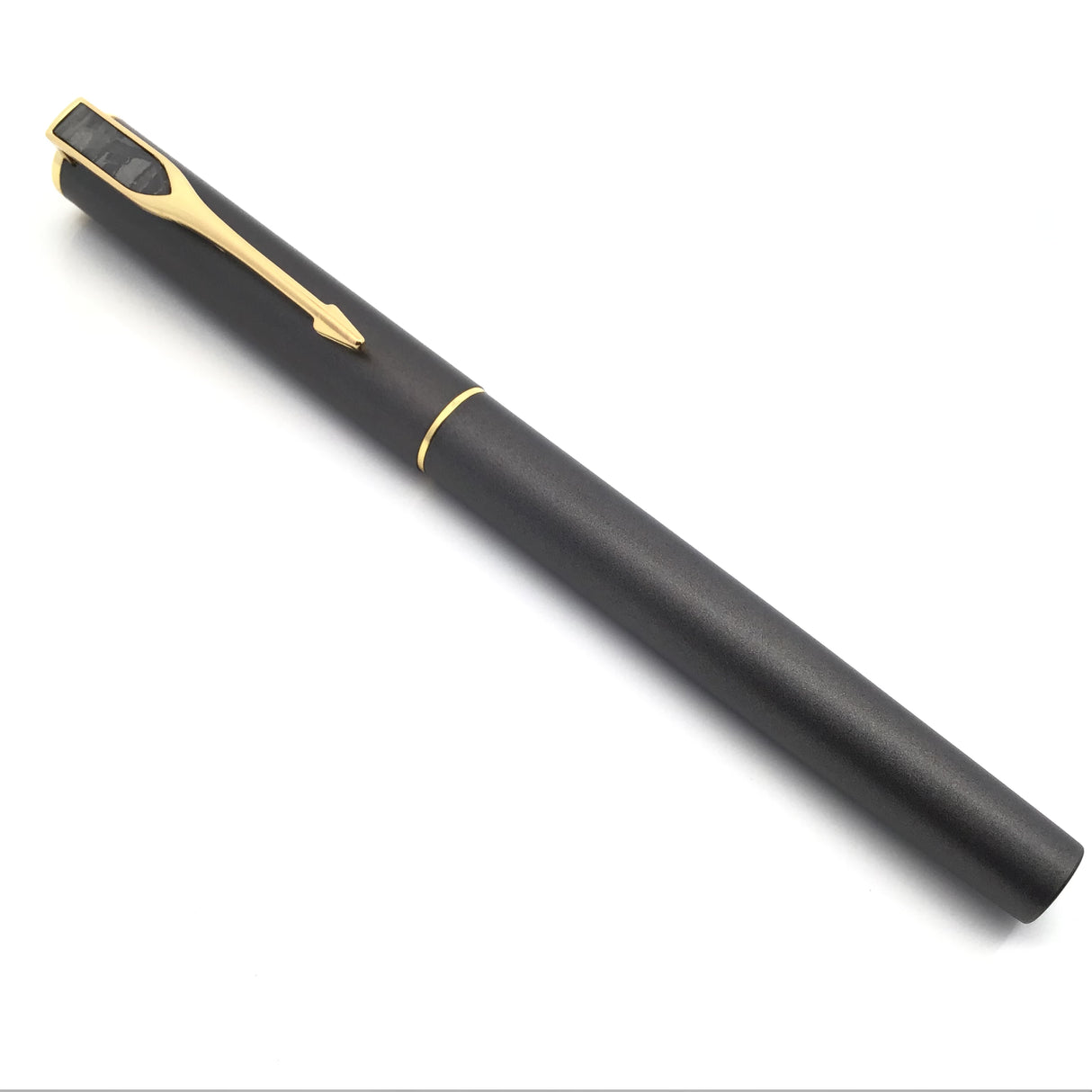 Capped Muonionalusta meteorite pen shown full length, gold clip topped with a crosshatched meteorite pennant