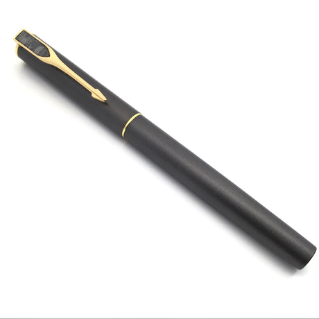Capped Muonionalusta meteorite pen shown full length, gold clip topped with a crosshatched meteorite pennant