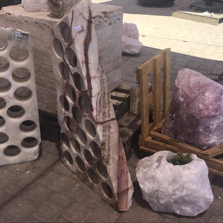 Angled view of the 21-hole serpentine onyx wine rack showing slab thickness and tapered shape