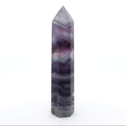 Rainbow fluorite tower point with chevron purple and grey-green banding, polished six-sided faces on white