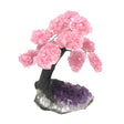 Rose quartz gemstone tree on a tall crystalline amethyst geode base, three-quarter view