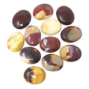 Twelve polished Mookaite Jasper palm stones in burgundy, mustard and cream arranged on white