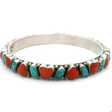 Turquoise and coral heart bangle bracelet, angled view of scalloped silver bezels and beading