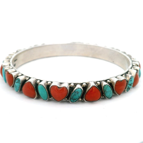 Turquoise and coral heart bangle bracelet, angled view of scalloped silver bezels and beading
