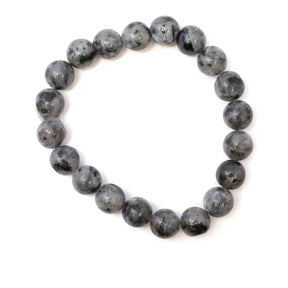 Larvikite 10mm bracelet featuring round gray-black beads arranged in a circular shape on a white background.