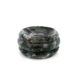 Dark gray and black speckled gemstone sphere stand disc with polished grooved rim on white