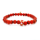 Bracelet 6 mm en corail rouge avec perle œil grec